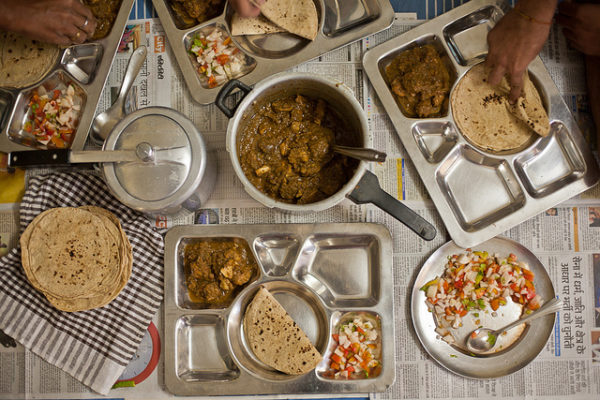Relishing my dad's chicken curry in India.